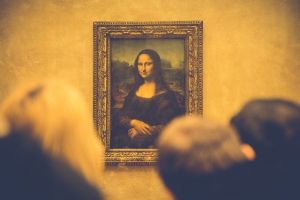 Des personnes contemplent la peinture de la Joconde dans le musée du Louvres